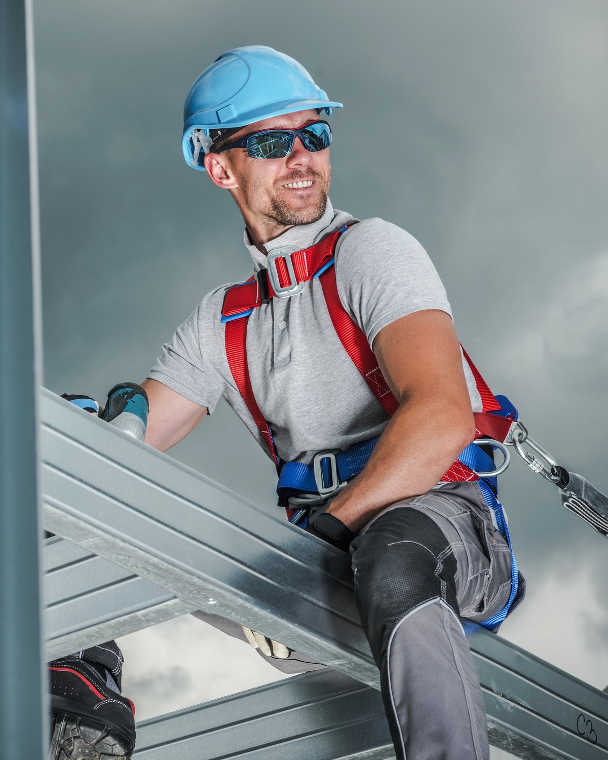 Steel worker wearing fall protection equipment